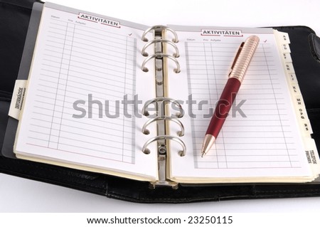 Black personal diary with red pen isolated on white