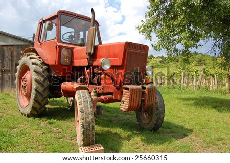 Old red tractor in the vineyard