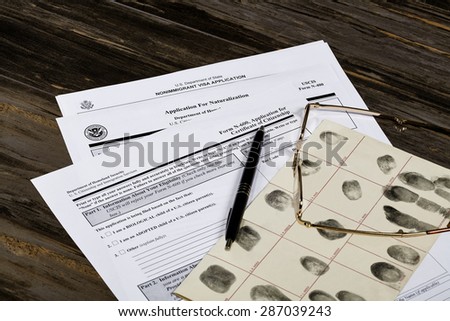 USA America Citizenship Application with glasses. Public documents and studio props.