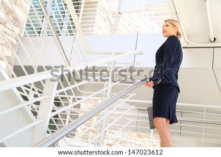 young businesswoman walking on stairs