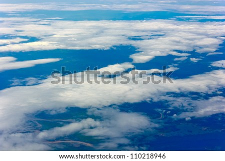 blue sky high view from airplane clouds shapes and see the land below
