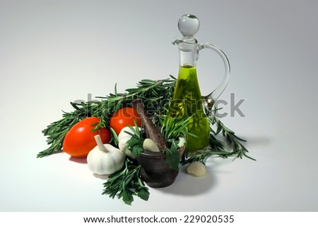 Tomatoes, garlic, olive oil and fresh spicy herbs for sauce preparation