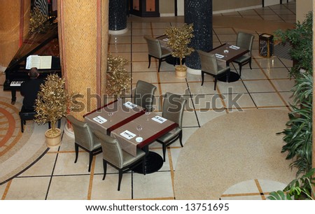 Luxury hotel hall restaurant with the musician playing on the piano
