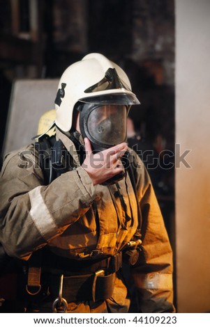 Fireman in fire protection suit and mask