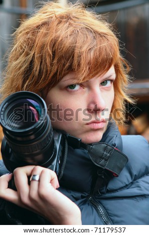 Young woman paparazzi photographer. Portrait