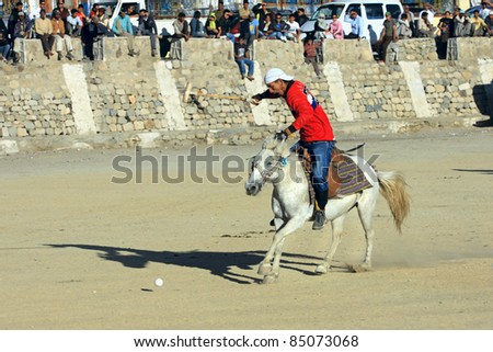 LEH,  LADAKH - SEPTEMBER 3: An unidentified polo player charges after the ball at a match in Leh\'s polo grounds on September 3, 2011, in Leh, Ladakh.