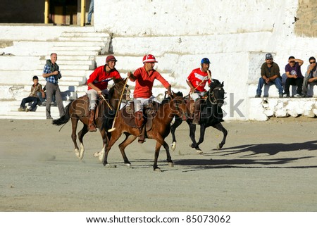 LEH,  LADAKH - SEPTEMBER 3: Unidentified  polo players charge after the ball at a match in Leh's polo grounds on September 3, 2011, in Leh, Ladakh.