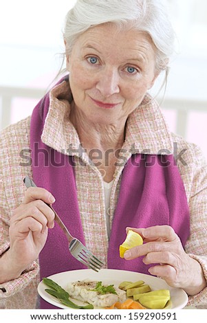 elegant senior woman eating healthy food
