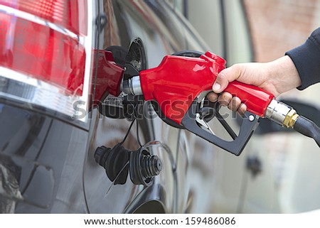 Gasoline pump refilling automobil fuel. Shallow focus.