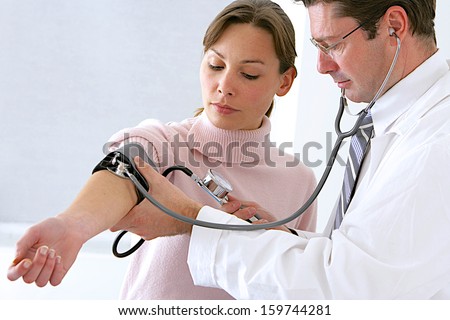 Doctor And Patient Blood Pressure Check Up - Female Patient'S Arm Extended