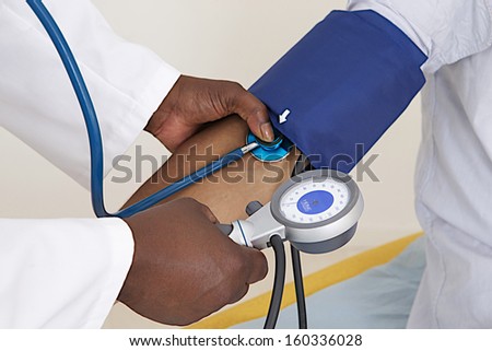 medical check up - focus on blood pressure and manometer and patient arm