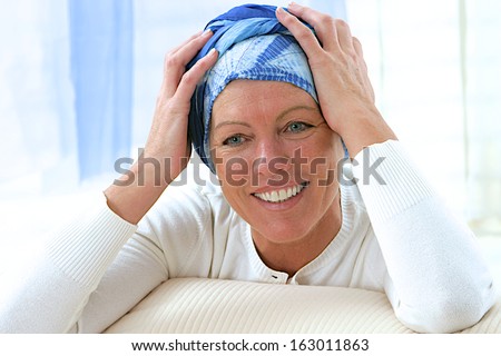 portrait of a smiling courageous middle aged woman after chemotherapy