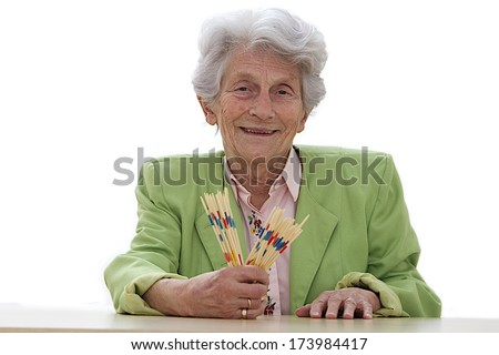 senior woman ready to play mikado in retirement home