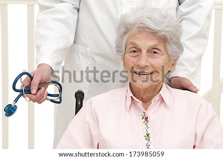 caring doctor with disabled  senior patient in office