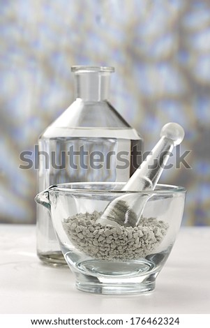 preparation  of  cosmetic clay for spa treatments in glass mortar with bottle of water
