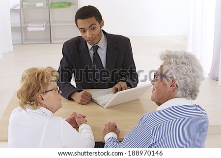Financial consultant presents bank investments to an elderly couple