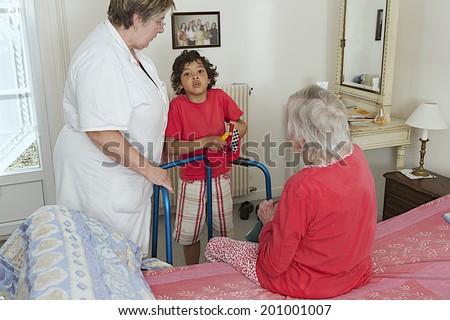 home hospitalization-grand son visiting his grand mother with care giver