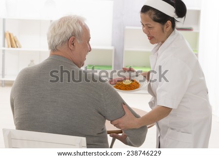 Senior woman eats lunch at retirement home (care, home, elderly)
