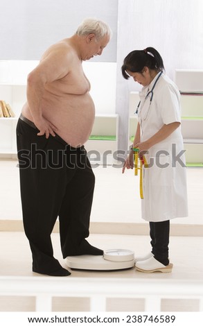 Overweight  senior man measuring his weight with doctor