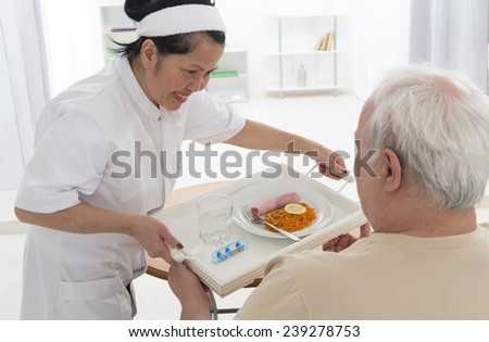 Senior man eats lunch at retirement home (care, home, elderly)