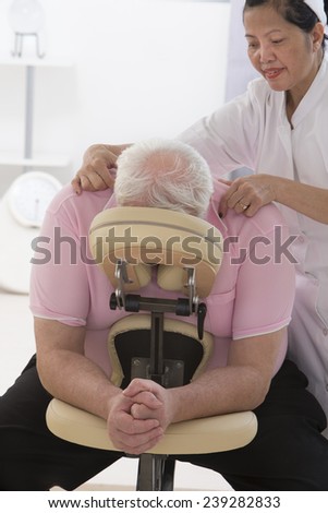 overweight man having massage in a massage chair
