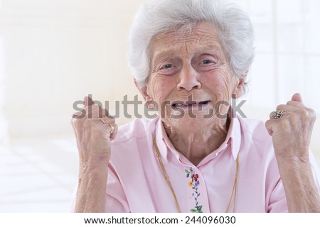 Angry old woman making fists