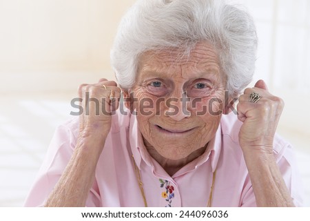 Angry old woman making fists