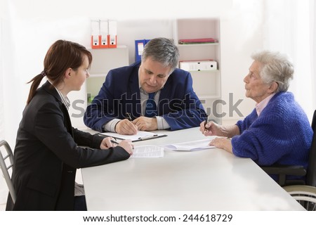 Grand mother signing insurance contract and donation to her grand daughter