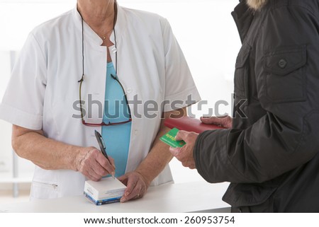 Female pharmacist talking to patient about the medical prescription