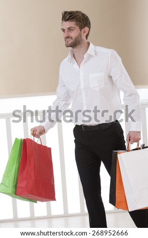 Portrait of a handsome young man with shopping bags
