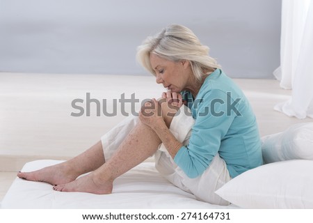 Senior  woman holding the knee with pain