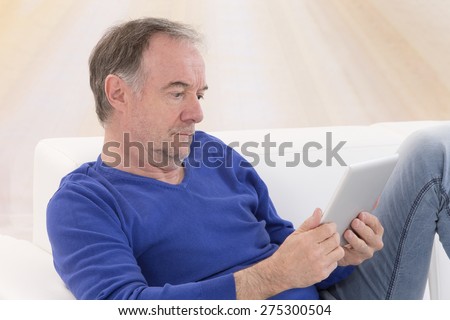 Portrait of senior man using digital tablet PC