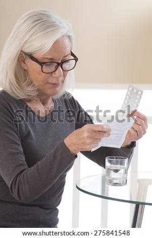 Senior woman reading medical Notice