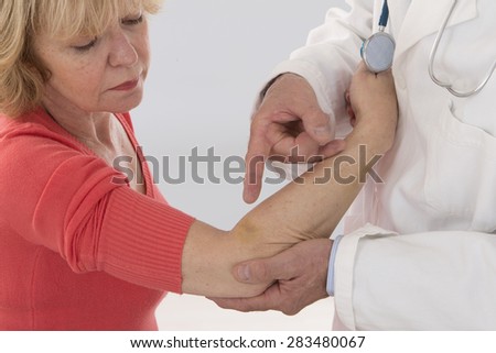 Senior woman injured arm medical  examination
