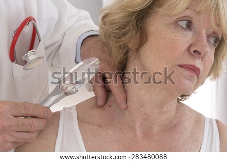 dermatologist focus on senior woman beauty spot
