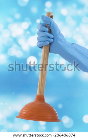 woman gloved hand with rubber plunger isolated