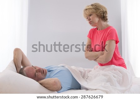 Portrait Of Senior Angry Woman Awaken By Her Husband Snoring