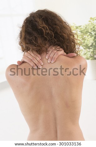woman with both hands on shoulder (back, woman, pain)