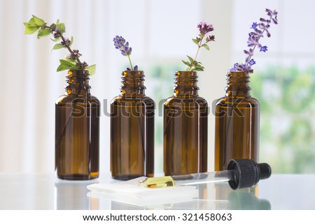 brown bottle  with aromatic herbs for essential oil