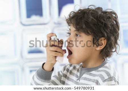 Boy using  nasal spray bottle.- allergy concept