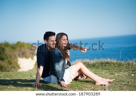 happy young couple on holiday by the sea in summertime