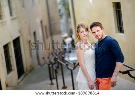 cheerful young couple on holiday sightseeing and visiting