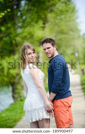 cheerful young couple on holiday sightseeing and visiting