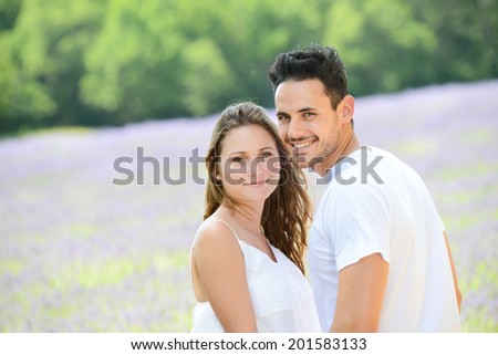 romantic young couple, man and woman during summer holiday having fun in lavender field in provence south France