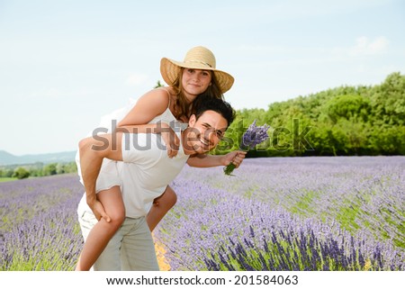 romantic young couple man and woman in summer holiday having fun lavender field provence south France