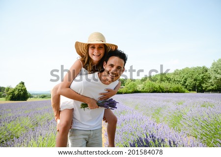 romantic young couple man and woman in summer holiday having fun lavender field provence south France
