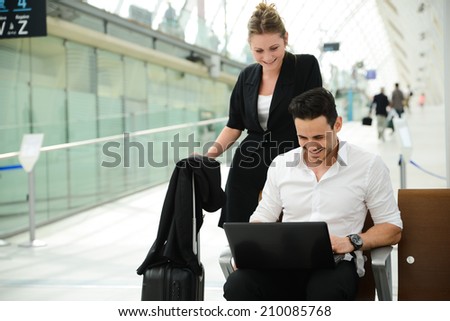 business people man and woman sitting in public station and working with computer in public wifi area