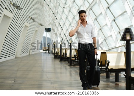 handsome young businessman walking in a public transportation station