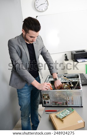 young man computer home repair fixing a computer