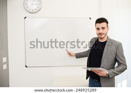 young business man or teacher showing on white board